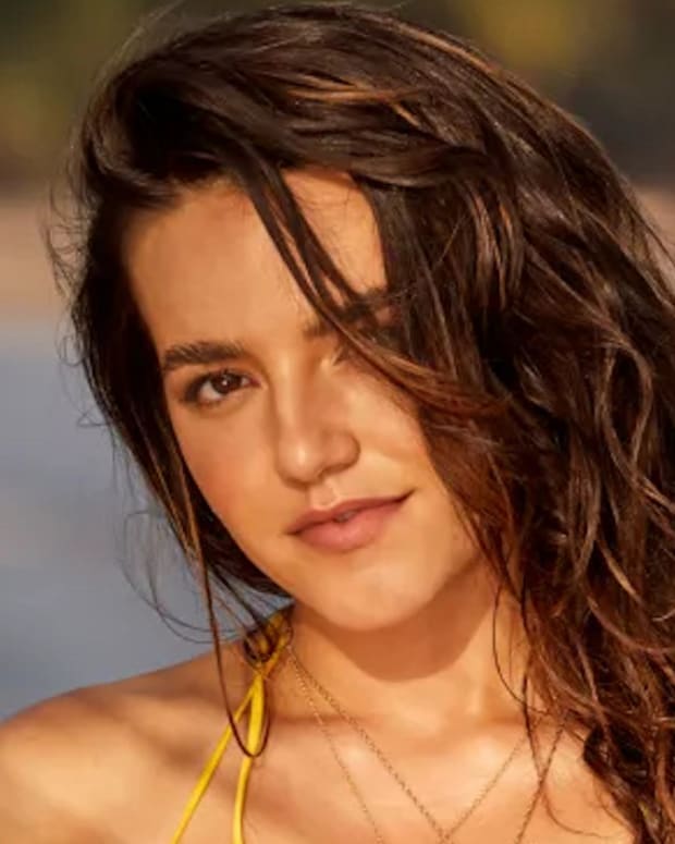 Mady Dewey poses in a yellow string bikini and a wavy down-do.